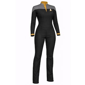 May include: A black jumpsuit with long sleeves, a high collar, and a gold accent. The shoulders are gray, and a gold emblem is on the chest. The cuffs and collar have gold trim. The jumpsuit has a fitted silhouette.