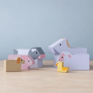 Könnte beinhalten: Eine Sammlung farbenfroher, geometrischer Bauernhoftierspielzeuge. Das Set enthält einen beigen Hund, ein rosa Schwein, eine graue Kuh, ein weißes Schaf und eine gelbe Ente. Jedes Spielzeug hat einfache, blockartige Formen und bemalte Details.