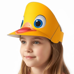 May include: A yellow duck visor with a cartoon duck face design. The visor features large blue eyes, an orange beak, and a pink tongue. The visor is worn by a young person.