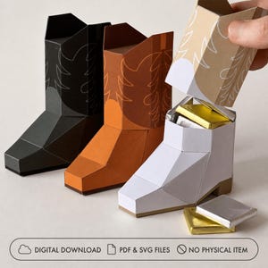 May include: Three paper cowboy boot boxes in black, brown, and white, with white decorative stitching patterns. The white boot is open, revealing gold and silver foil-wrapped square candies. Text reads: DIGITAL DOWNLOAD, PDF & SVG FILES, NO PHYSICAL ITEM.