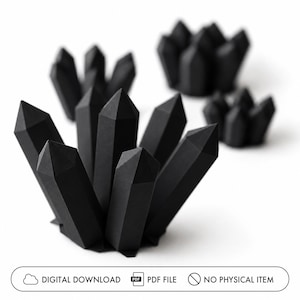 May include: Several black paper crystal sculptures are arranged on a white background. The crystals have sharp, geometric facets. The image also includes text that reads "DIGITAL DOWNLOAD", "PDF FILE", and "NO PHYSICAL ITEM".