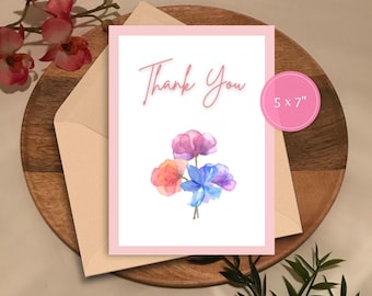May include: A pink thank you card with a watercolor illustration of three flowers in shades of pink, blue, and orange. The card measures 5 x 7 inches.