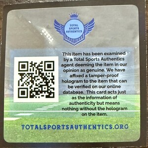 Puede incluir: Una tarjeta rectangular con un c&oacute;digo QR y texto de Total Sports Authentics. El texto indica que el art&iacute;culo ha sido examinado y considerado genuino, con un holograma a prueba de manipulaciones para verificaci&oacute;n en su base de datos en l&iacute;nea.