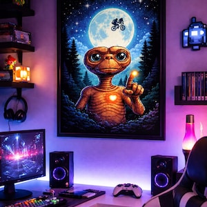 May include: A framed poster featuring E.T. pointing with a glowing finger, set against a backdrop of a full moon and a forest. The room is a gaming setup with a computer, speakers, and a controller, illuminated by purple LED lights.