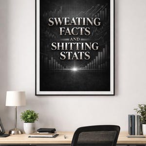 May include: A framed black and white print with the text "SWEATING FACTS AND SHITTING STATS" in silver lettering. The print has a dark background with bar graphs and upward trending arrows. The print is displayed above a desk.