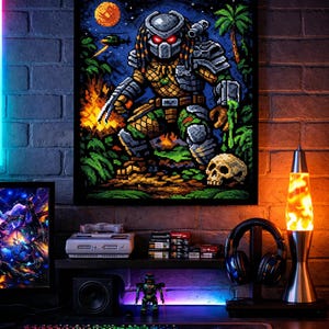 May include: Pixelated art print of the Predator alien, set against a night sky with a moon and palm trees. The artwork is displayed above a gaming setup with a keyboard, monitor, and lava lamp.