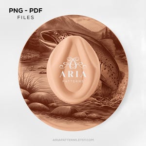 May include: A round, salmon-colored plate with a detailed illustration of a fish jumping out of a river. A salmon-colored, oval-shaped object with the text "ARIA PATTERNS" is centered on the plate. The words "PNG - PDF FILES" are in the upper left corner.