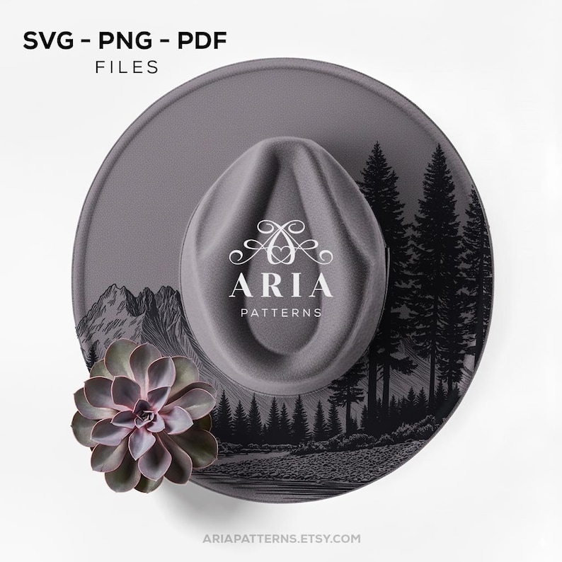 May include: A gray fedora hat with a landscape design featuring mountains and trees. The hat has a decorative succulent and the text "SVG - PNG - PDF FILES" and "ARIA PATTERNS".