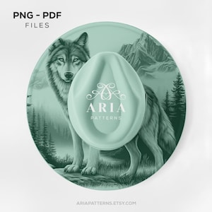 May include: A round, mint green coaster featuring a detailed illustration of a wolf in a forest setting. The coaster has the text "PNG - PDF FILES" at the top and a mint green object with the text "ARIA PATTERNS" in the center. The website address "ARIAPATTERNS.ETSY.COM" is at the bottom.