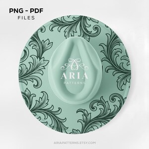 May include: A round, mint-green hat with a decorative floral pattern and the text "ARIA PATTERNS". The hat has a curved brim and a central indentation. The words "PNG - PDF FILES" are at the top.