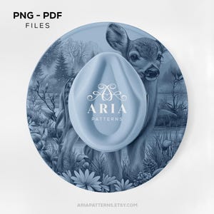 May include: A light blue, circular design featuring a deer illustration, with a matching light blue, oval-shaped object in the centre. The object has the text "ARIA PATTERNS" in white. The image also includes the text "PNG - PDF FILES" and "ARIAPATTERNS.ETSY.COM".