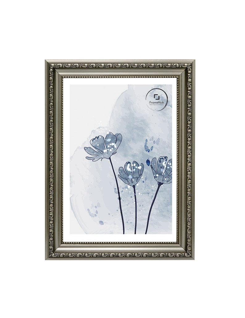 May include: Silver-toned picture frame with ornate detailing. The frame surrounds a print featuring blue watercolor flowers against a light blue background. The print has the text "FrameHub" in the upper right corner.