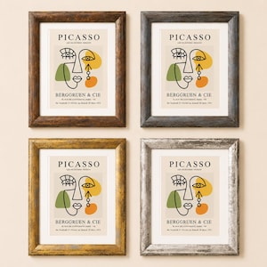 May include: Four framed art prints featuring a Picasso exhibition poster from Berggruen & Cie. The prints display a stylized abstract face with black lines, green, yellow, and orange shapes. The frames come in dark brown, black, gold, and silver finishes.