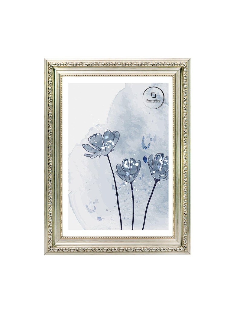 May include: A rectangular silver picture frame with ornate detailing surrounds a print of blue watercolor flowers. The artwork features three stylized flowers with dark stems against a light blue and white background. The FrameHub logo is visible.