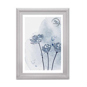 May include: A rectangular white picture frame with ornate detailing surrounds a print of blue watercolor flowers. The artwork features three stylized flowers with dark stems against a light blue and white background. The FrameHub logo is visible.