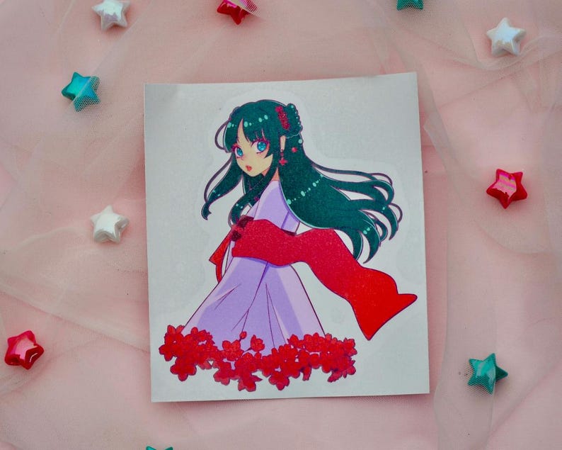 May include: A sticker featuring a cartoon illustration of a young woman with long, dark green hair wearing a purple dress and a red scarf. She is surrounded by red flowers.