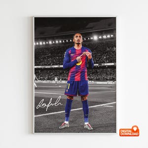 May include: A framed digital download print of a footballer in a blue and red striped jersey, number 17. The player stands on a pitch, with a stadium and crowd in the background. The player's signature is at the bottom of the print.