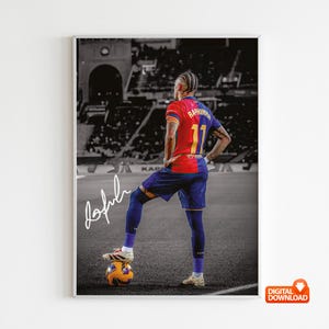 May include: A framed digital download featuring a soccer player in a red, blue, and yellow jersey with the number 11. The player is standing on a soccer ball, with one foot on top. The background is a black and white stadium scene. The player's signature is visible.