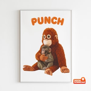 Puede incluir: Impresión enmarcada que presenta un orangután de peluche abrazando a un bebé orangután. Los orangutanes son marrones y tostados, con ojos grandes. La palabra "PUNCH" está escrita en letras naranjas en la parte superior de la impresión. Fondo blanco.