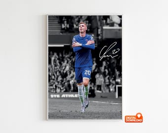 May include: A framed digital print featuring a soccer player in a blue uniform with the number 20. The player is in a stadium, arms crossed, with a signature in the upper right corner. The background is in black and white.