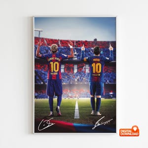May include: A framed digital print featuring two soccer players in Barcelona jerseys, with their backs to the viewer, raising their arms. The players are on a green field in front of a stadium filled with fans. Signatures are at the bottom.