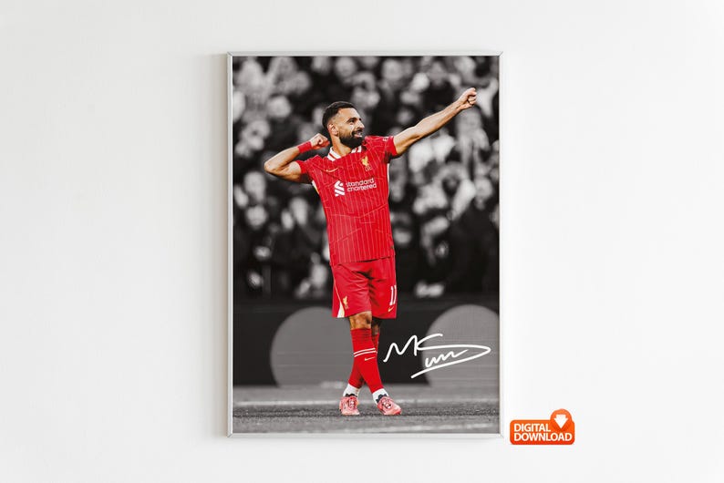 May include: Framed print of a footballer in a red kit, celebrating with arms raised. The background is a monochrome crowd. The player's signature is present. The image is labelled "DIGITAL DOWNLOAD".