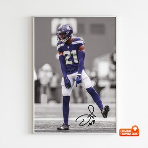 May include: A framed monochrome print of a football player in a navy blue uniform with the number 21. The player is on a field, with a signature at the bottom. The image is labelled "DIGITAL DOWNLOAD".