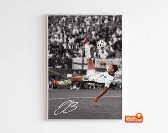 May include: Black and white framed print of a soccer player mid-air, kicking a soccer ball. The player wears a white jersey with the number 10. The background shows a crowd of people and the English flag. Includes a white signature.