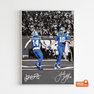 May include: A framed digital download featuring a black and white stadium crowd background with two football players in blue uniforms. The players are running and holding hands. The image includes signatures and the text "DIGITAL DOWNLOAD".