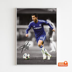 May include: A framed black and white photograph of a soccer player in a blue uniform with the number 10. The player is running with a soccer ball at his feet. The photograph includes the player's signature.