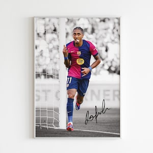 May include: A black and white photo of a soccer player wearing a blue and red jersey with the number 11 on it. The player is running towards the camera with his arm raised. The photo is signed "Jofrhl" in black ink.