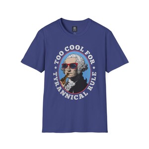 May include: Blue t-shirt featuring a graphic of George Washington wearing sunglasses and holding a beer bottle. The graphic is in a circular design with the text "TOO COOL FOR TYRANNICAL RULE".