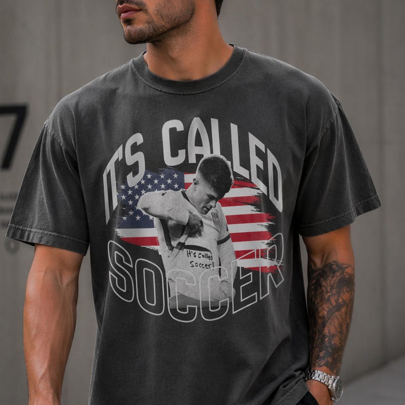 Gray soccer fan t-shirt with bold “It’s Called Soccer” print, American sports theme, streetwear