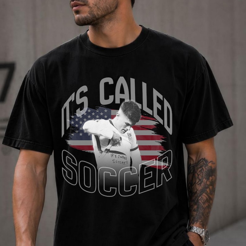 Black Comfort Colors soccer shirt with USA flag print, funny “It’s Called Soccer” design, men’s casual outfit