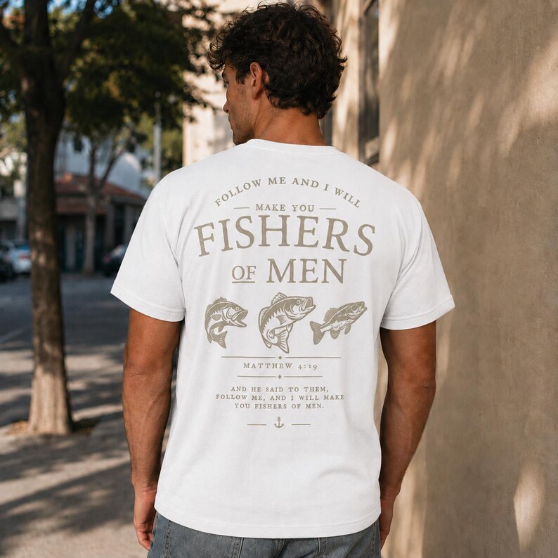 White Christian fishing shirt mockup showing large Fishers of Men scripture design on back with detailed fish artwork and Matthew 4:19 verse on male model.