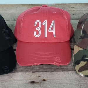 May include: Three baseball caps with distressed fabric. Each cap features a white embroidered number "314" on the front. The caps are black, red, and camouflage.