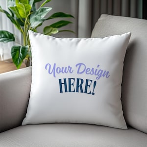 May include: White throw pillow with the text "Your Design HERE!" in blue and purple lettering.