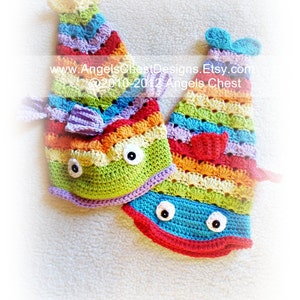 May include: Two colourful crocheted fish toys with rainbow stripes and googly eyes. www.AngelsChestDesigns.Etsy.com ©2010-2012 Angels Chest
