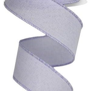 May include: A roll of lavender-colored wired ribbon with a textured, linen-like finish. The ribbon has a white edge and is perfect for crafting and decorating.