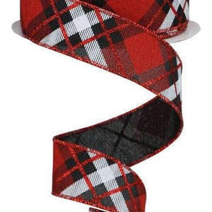 May include: Red, black, and white plaid ribbon with a silver glitter accent. The ribbon is rolled on a spool.