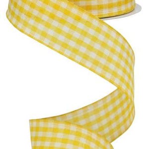 May include: A roll of yellow gingham ribbon with white checks. The ribbon is 2.5 inches wide.