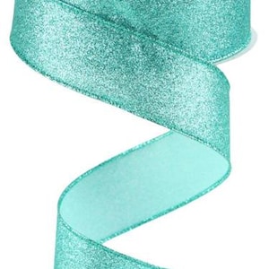 May include: A roll of teal satin ribbon with a shimmery finish.