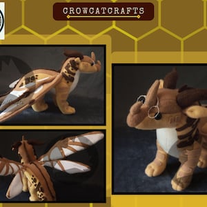 May include: A plush dragon toy in shades of tan, brown, and cream. The dragon has detailed wings, horns, and a long tail. The image includes multiple views of the dragon, showcasing its design and craftsmanship. The text "CROWCATCRAFTS" is visible.