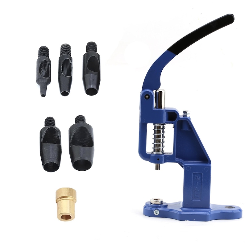 May include: A blue and black hand press tool with a lever, spring, and various black metal dies. A brass fitting is also included. This tool is likely used for setting grommets, snaps, or other fasteners in fabric or leather.