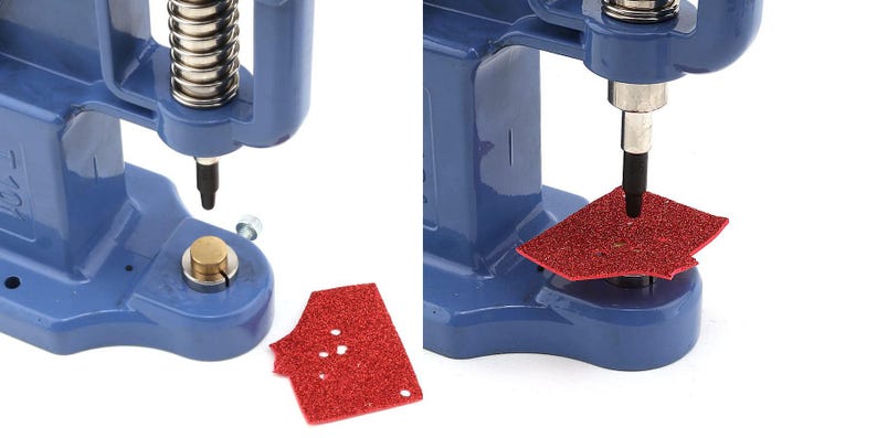 May include: Close-up of a blue press machine with a silver spring and black punch. A red, glittery piece of material is being punched. The machine is designed for crafting and creating custom designs.