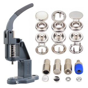 May include: A gray snap press machine with a black handle and silver metal components. The image also shows various silver snaps and tools, including button caps, snap rings, and setting dies. The tools are for attaching snaps to fabric.