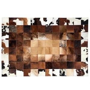 May include: A rectangular cowhide rug with a patchwork design. The rug features squares of brown, tan, and white cowhide. The color palette includes shades of brown, tan, and white, creating a natural and rustic aesthetic. The rug is suitable for a living room or bedroom.