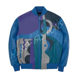 May include: A blue, purple, and gray leather bomber jacket with a full zipper closure. The jacket features a color block design with various geometric shapes. The sleeves and collar are solid blue, and the text "HUB OF FASHIONS" is visible.