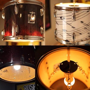 May include: Drum lamps with a musical theme. One lamp has a red and black gradient finish, the other is white with musical notes. Both have chrome hardware and are lit from within. The lamps are suspended from the ceiling.