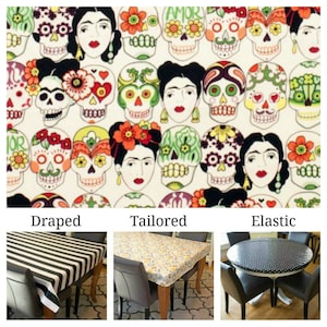 May include: Three tablecloths in different styles: draped, tailored, and elastic. The tablecloth fabric features a colorful pattern of sugar skulls and flowers. The draped tablecloth is black and white striped, the tailored tablecloth is yellow and white floral, and the elastic tablecloth is black and white polka dot.